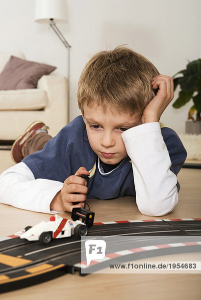Boy (6-7) playing with toy cars