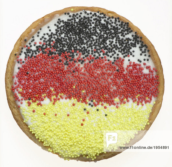 Sweet pastry with German-flag-colored sugar beads  elevated view  close-up