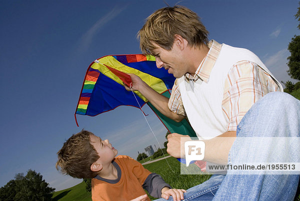 Father and son (4-7) with kite  close-up