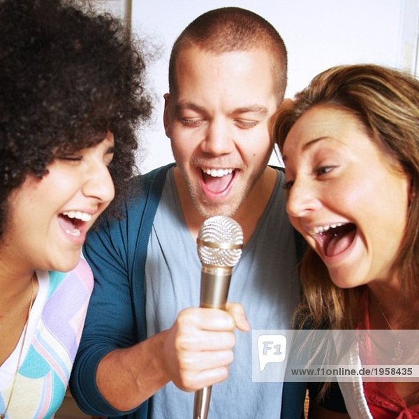 Three persons singing