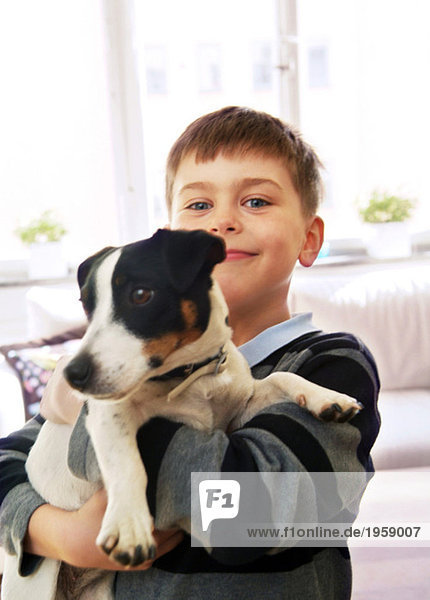 Boy holding dog in his arms