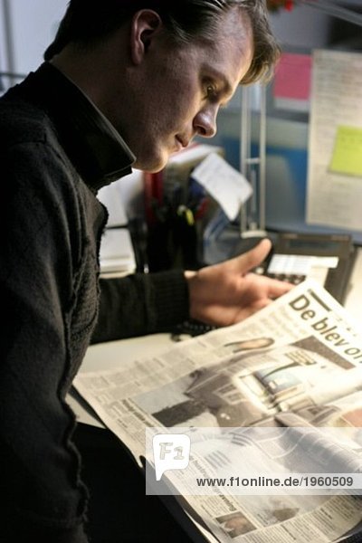 Junger Mann mit Zeitung