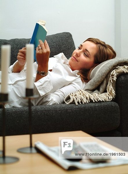 Young woman reading in couch