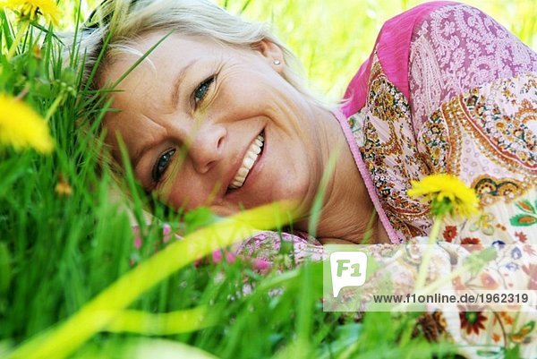 Blonde woman in grass