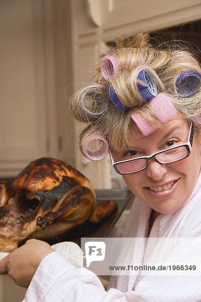 Housewife with burnt turkey in roasting tin