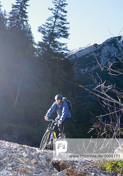 Mann fährt mit Mountainbike in den Bergen