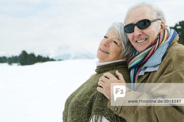Senior couple embracing  smiling  outdoors  portrait