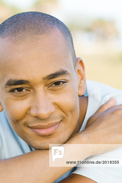 Man with shaved head smiling at camera  portrait
