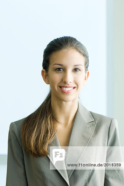 Young female in business attire smiling at camera  portrait