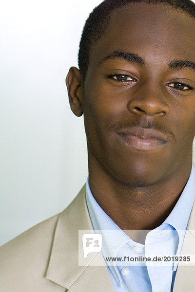 Young male in business attire smiling at camera  portrait