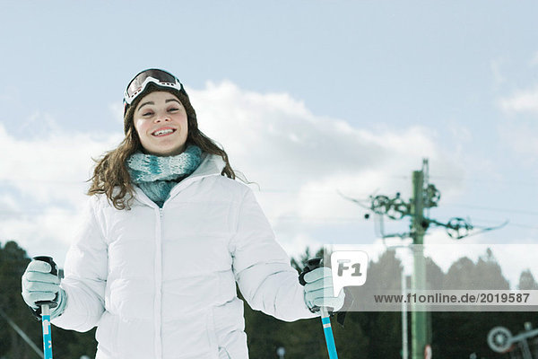 Young woman skiing  smiling at camera  portrait