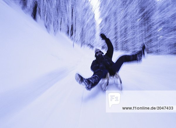 Blurred view of person sledding