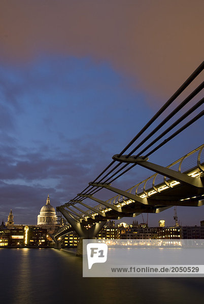 Bridge across river with cathedral in background  Millennium Bridge  Thames River  St. Paul's Cathedral  London  England