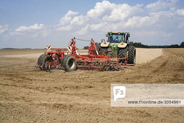A tractor plowing a field