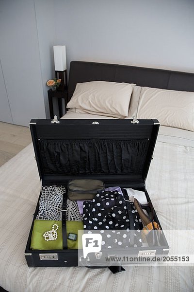 An open suitcase on a bed