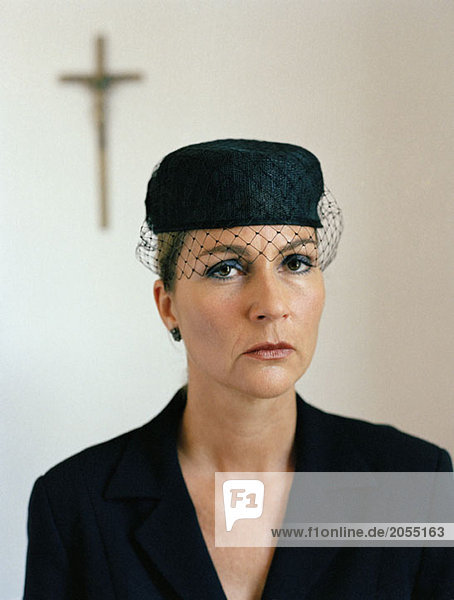 Portrait of a woman dressed in black at a church