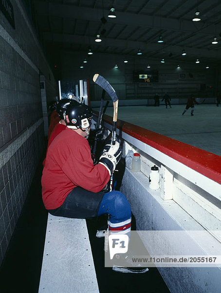 Ice hockey players sitting on the bench