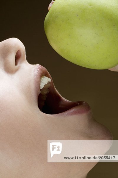 A woman eating an apple