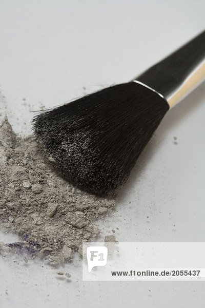A make-up brush with grey eyeshadow