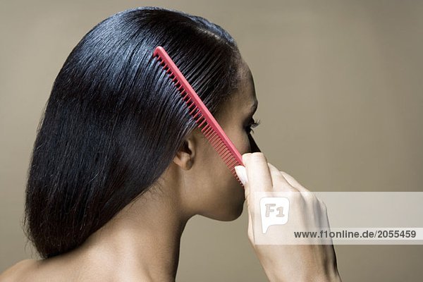 A woman combing her hair
