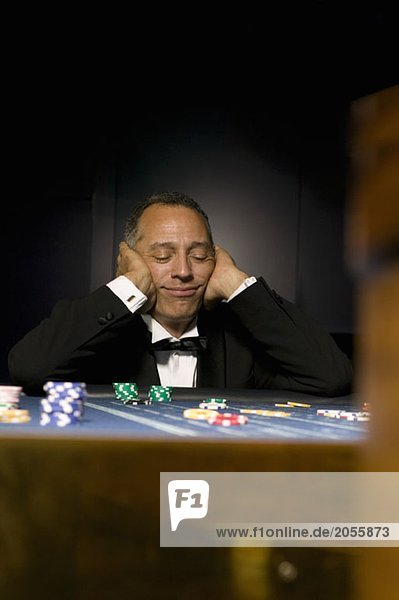 Man losing at casino table