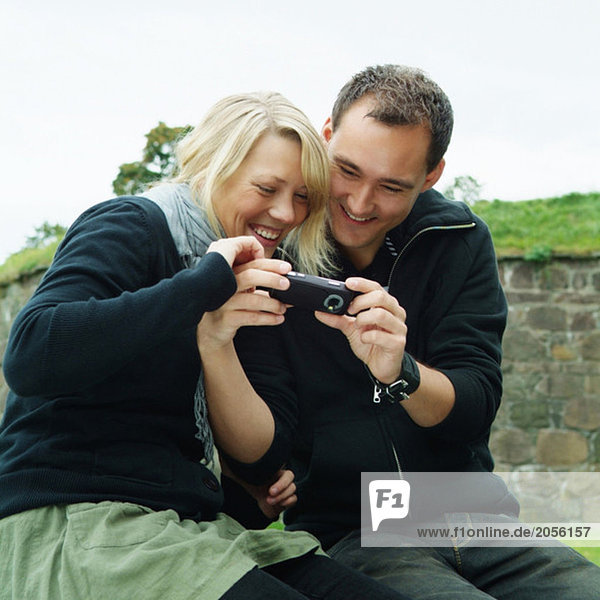 Girl and guy looking at a cell phone