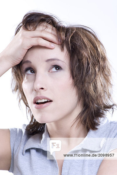 Woman looking up  hand on head  portrait