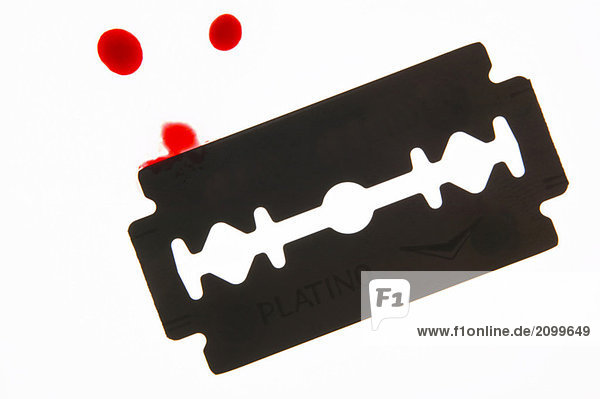 Razor blade with drops of blood  close-up