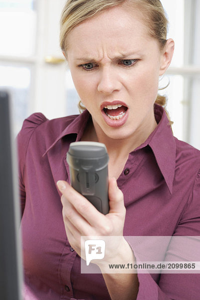 Woman shouting in telephone  close-up