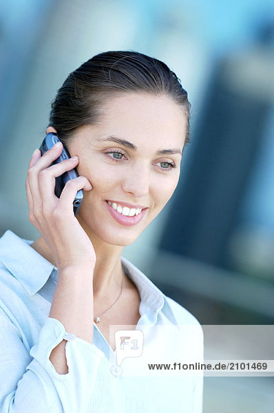 Businesswoman using mobile phone  smiling