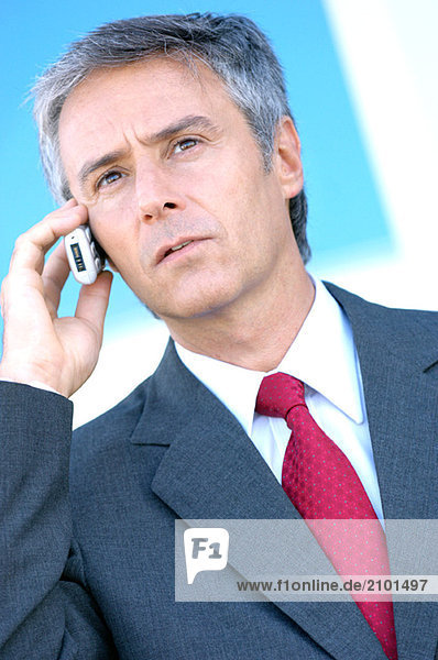Mature businessman using mobile phone  close-up