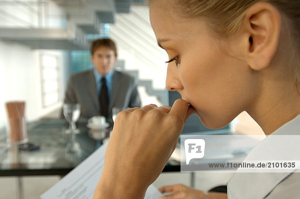 Businesswoman in office with colleague in background