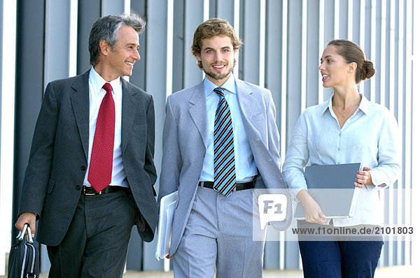 Business people walking together  smiling  portrait