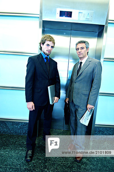 Businessmen waiting for elevator  portrait