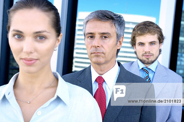 Business people standing in row  portrait