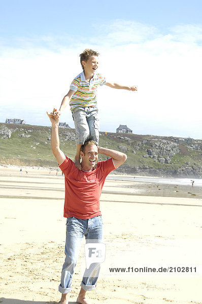 Man carrying his son on his shoulders