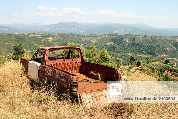 Abandoned car in field  Peloponnese  Greece