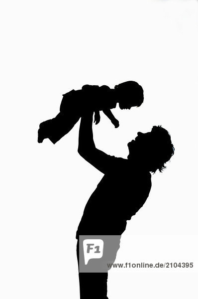Man lifting child  silhouette