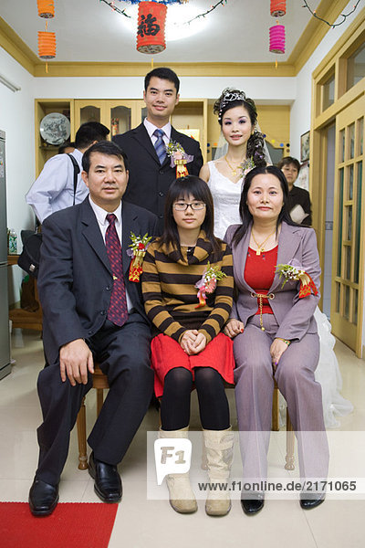 Brautpaar mit Familie  Gruppenporträt  volle Länge  Vorderansicht
