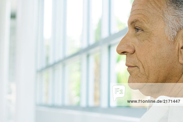 Mature man  profile  window in background  cropped