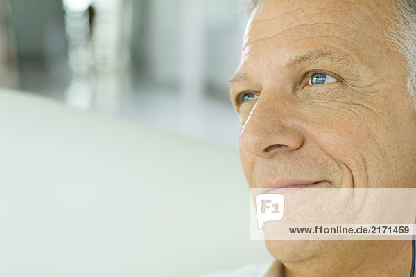 Mature man smiling  looking away  cropped view of face