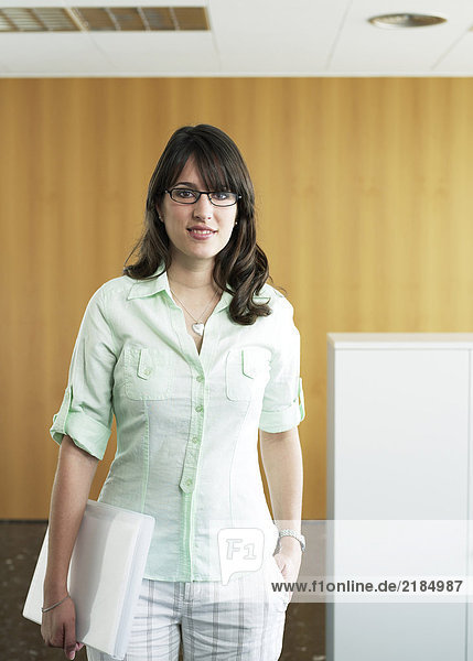 Young businesswoman standing in office  portrait