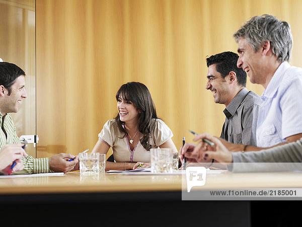 Businessmen and businesswoman in meeting  smiling