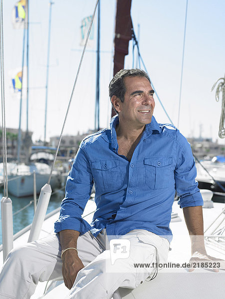 Mature man wearing relaxing on yacht  smiling