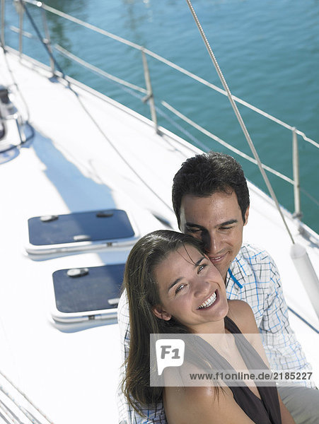 Young couple on yacht  woman smiling  portrait