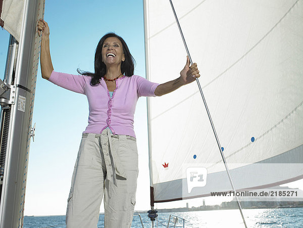 Reife Frau auf der Yacht stehend  lächelnd