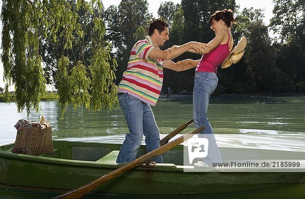 Man and woman balancing on boat