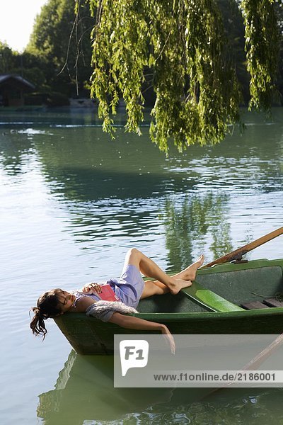 Woman lying down in a boat