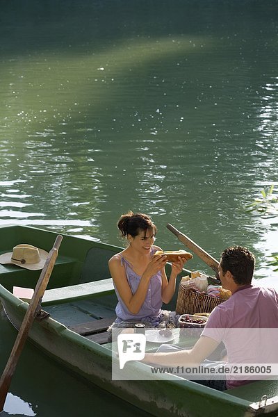 Man and woman having a picnic on boat