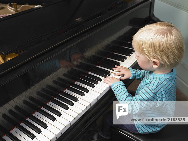 Little boy playing piano.